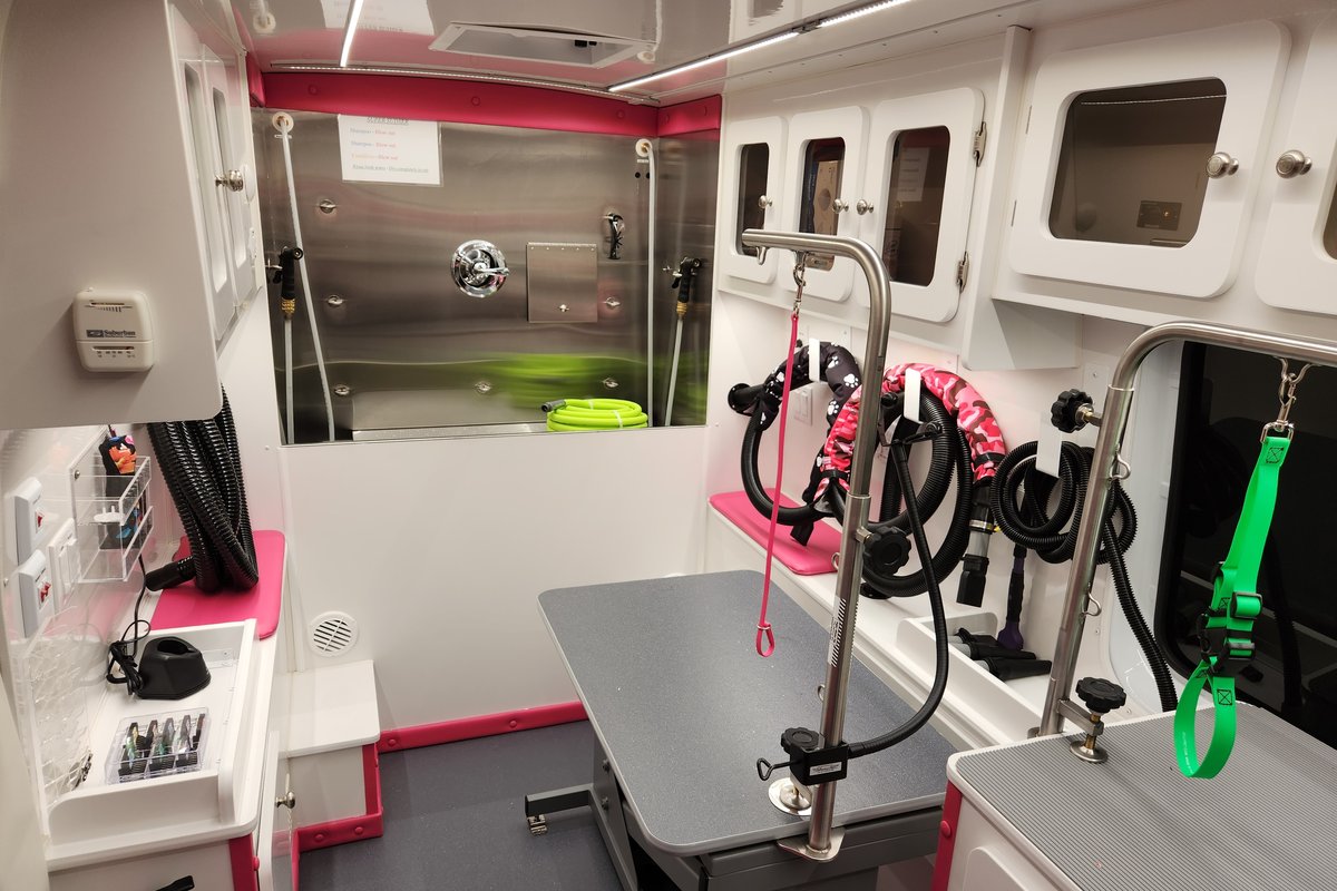 Inside the Bow Tie mobile grooming van showing the professional grooming station, tub, and equipment